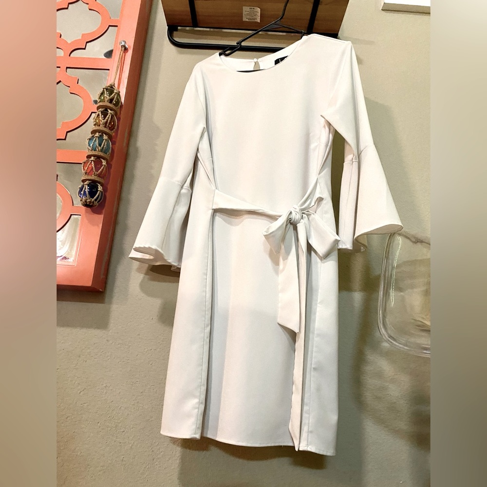 White Long Sleeve dress cute tying detail at mini skirt lends a wrap look.